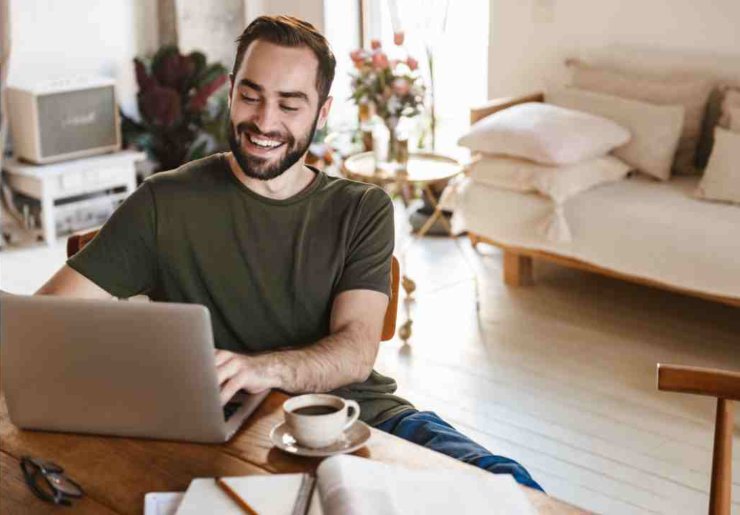 Uomo lavora da remoto con un pc